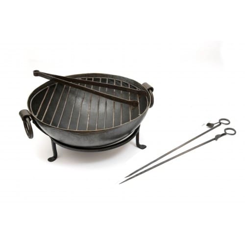 Discover the ultimate dining experience with our Small Table Top BBQ, the most compact and convenient addition to Kadai's range of barbecue essentials. This Table BBQ transforms any outdoor gathering, allowing you to grill right at the table while enjoying friends' company. Complete with a bespoke set of hand-crafted skewers and a robust grill, our Table Top BBQ ensures that every guest can tailor their meal to perfection. This all-in-one package includes everything needed for a seamless BBQ experience: the Table Kadai, a sturdy Stand, a high-quality Grill, Tongs, a set of 2 Skewers, Kadai Beads, and a heatproof Cork Mat for protecting your outdoor table. Elevate your outdoor dining to new heights with our small outdoor Table Top BBQ, a compact, efficient, and sociable grilling experience. Table Top BBQ handmade in mild steel Dia. 30cm x H16cm with stand / Skewers L36cm